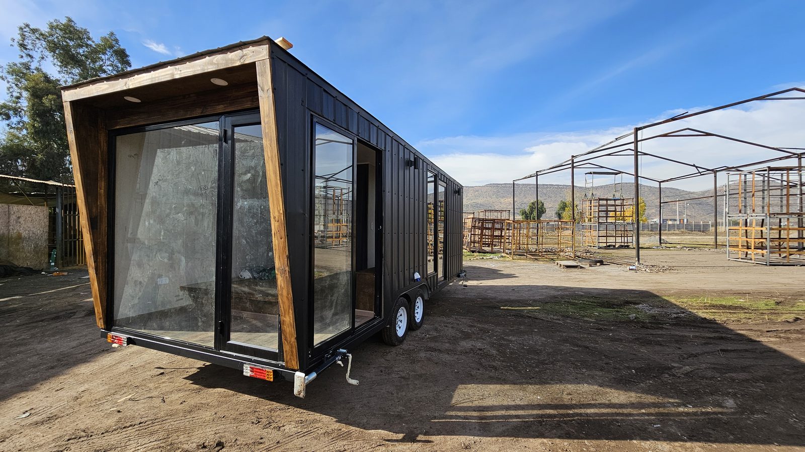 Modelo Un Piso: tiny house con fachada vidriada y marco de madera